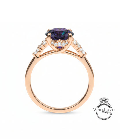 A gold ring with a large purple gemstone set in the center, surrounded by smaller diamonds.