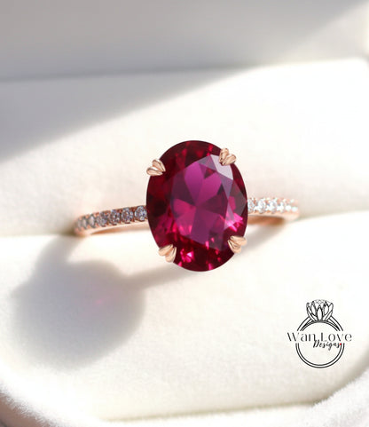 A close-up image of a pink gemstone ring with a large oval-shaped gemstone set in a gold band.