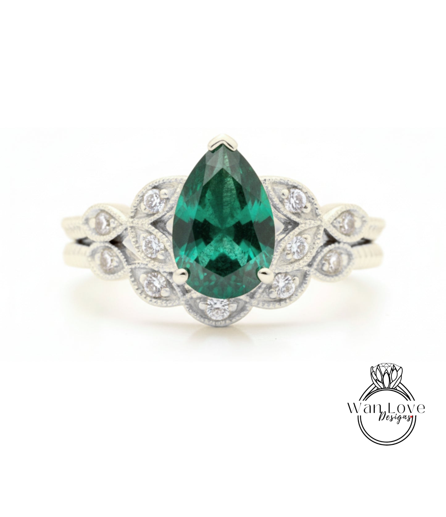A close-up of a silver ring with a large, green gemstone at the center, surrounded by smaller diamonds.