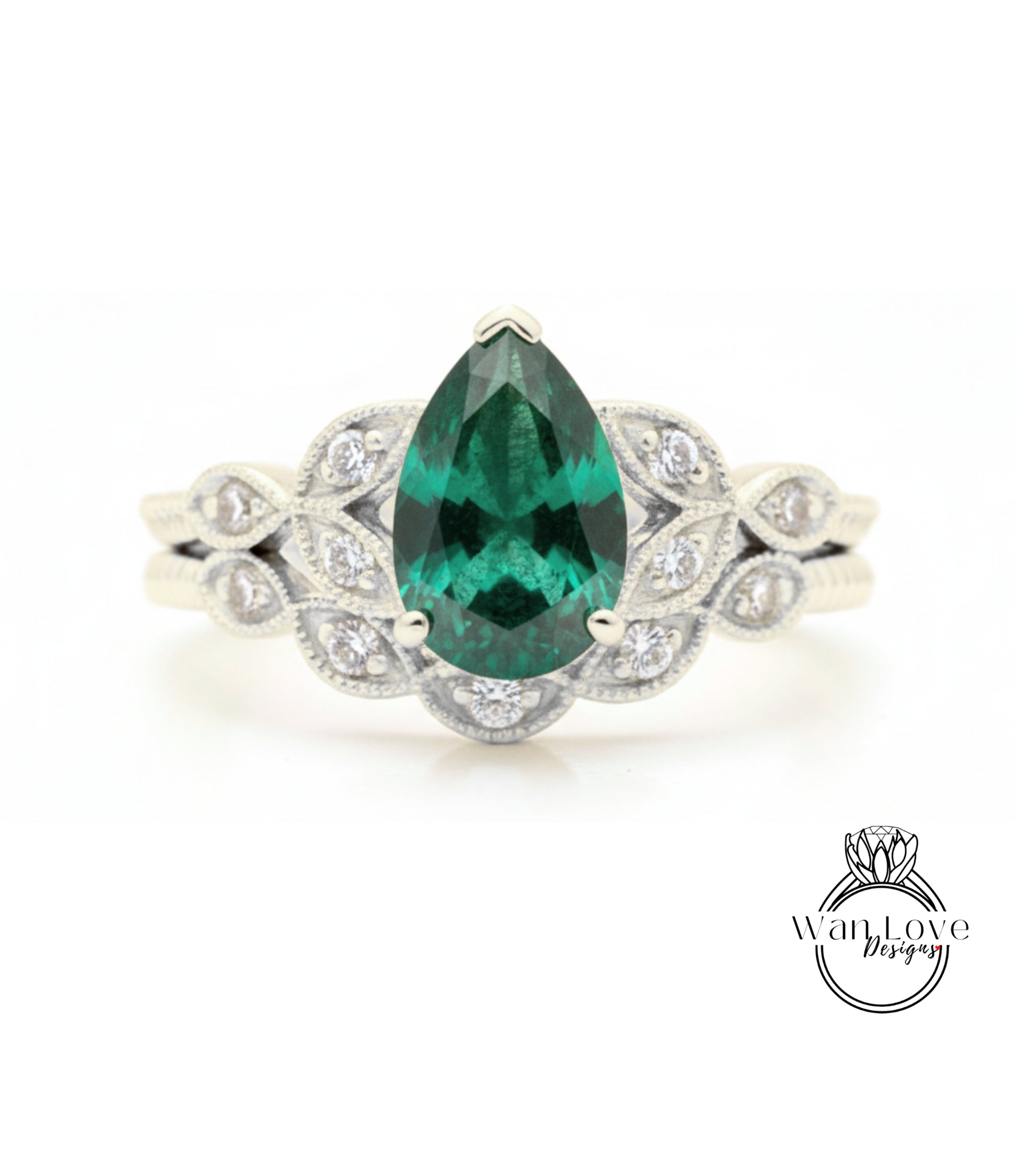 A close-up of a silver ring with a large, green gemstone at the center, surrounded by smaller diamonds.