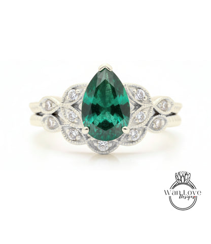 A close-up of a silver ring with a large, green gemstone at the center, surrounded by smaller diamonds.