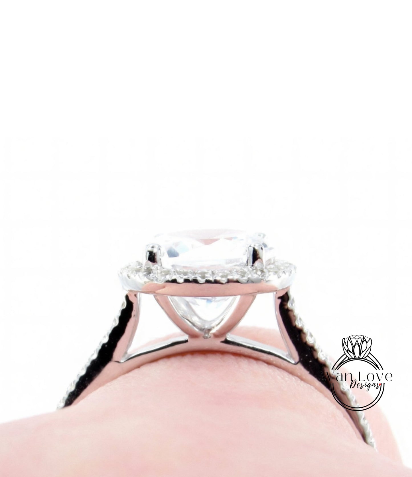 A close-up view of a diamond engagement ring on a person's hand, showcasing the intricate design and sparkling gemstone.
