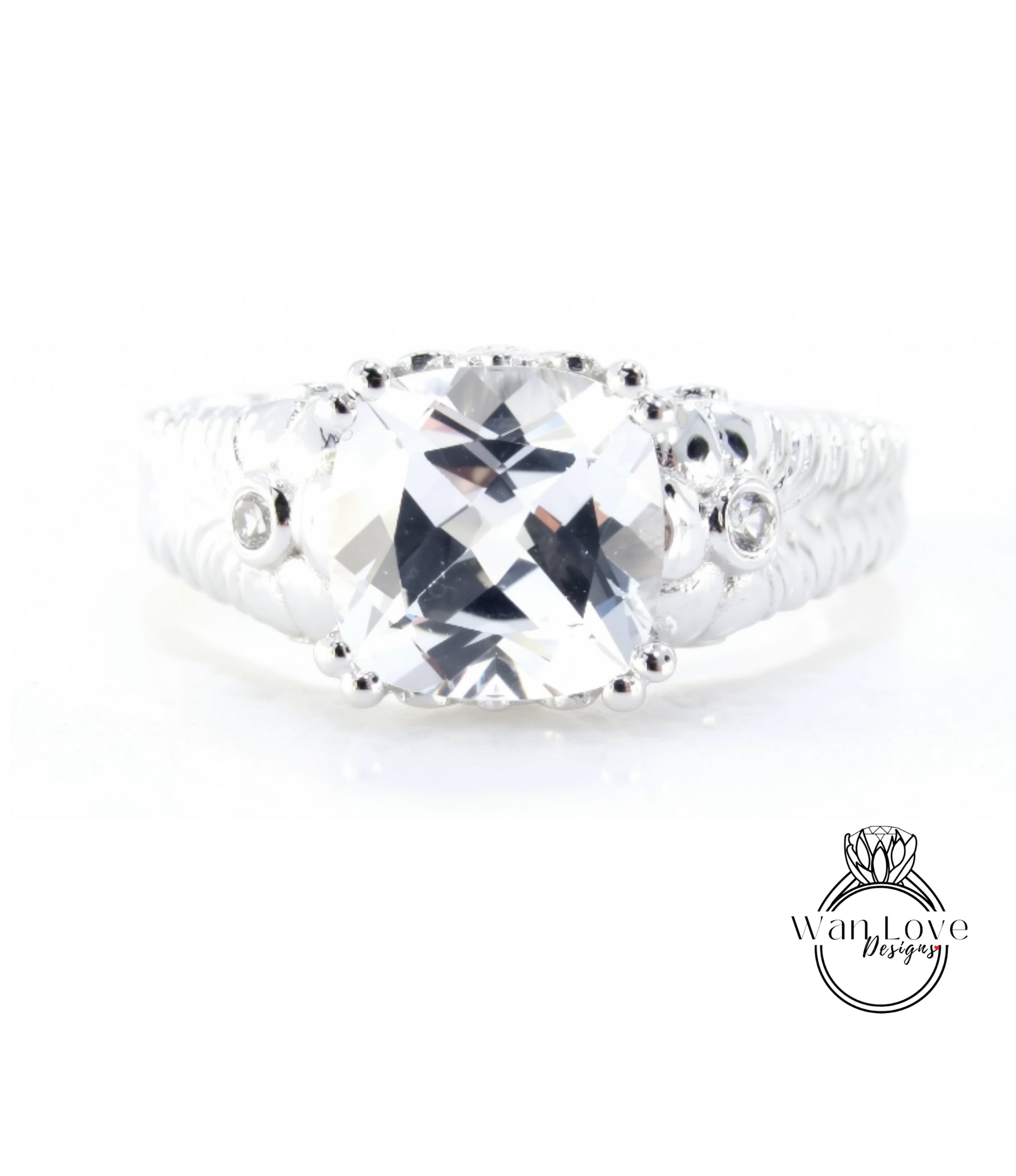 A close-up view of a diamond engagement ring with a large, clear gemstone set in a silver band.