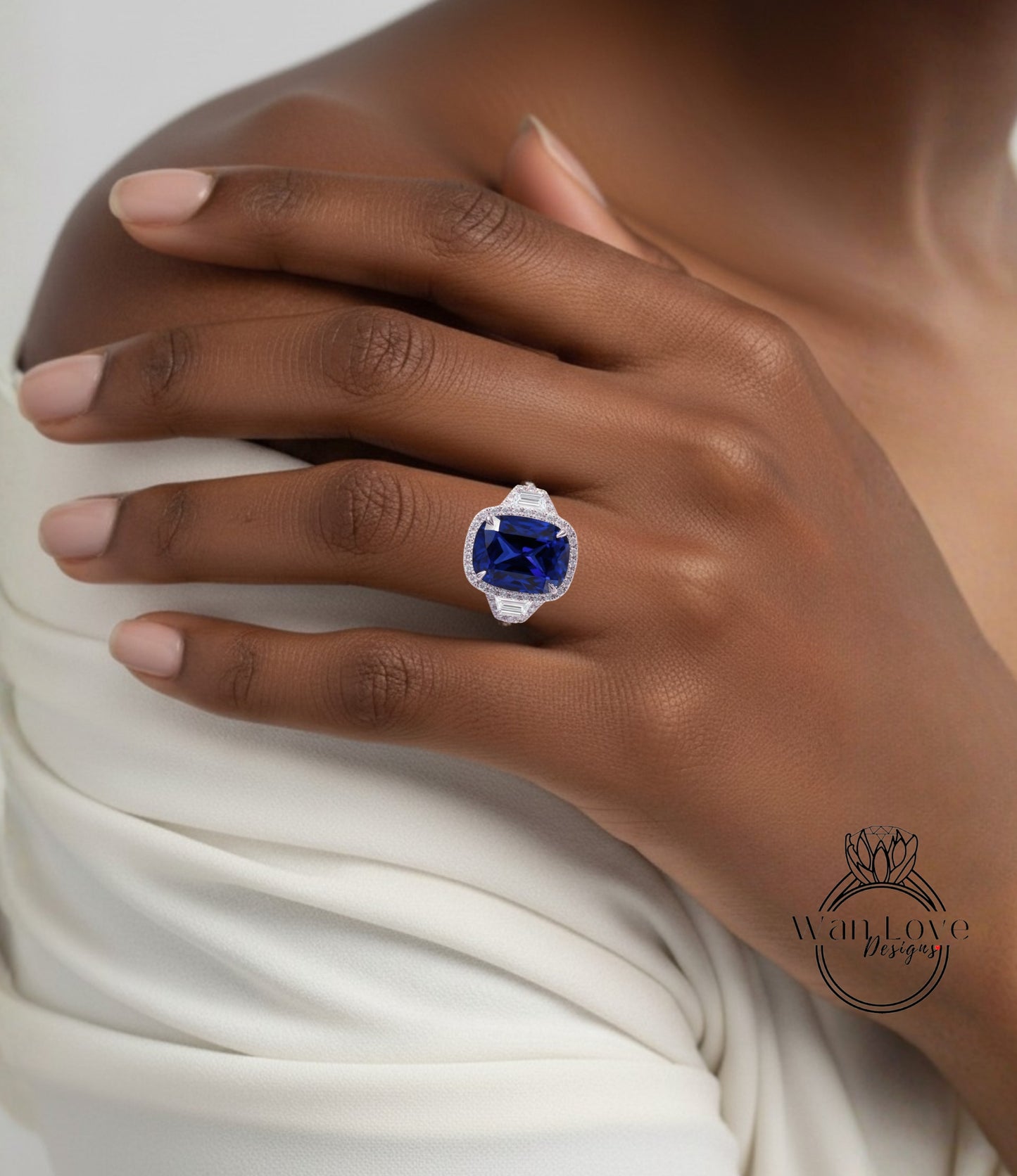 A close-up of a person's hand wearing a large, blue gemstone ring on the ring finger.