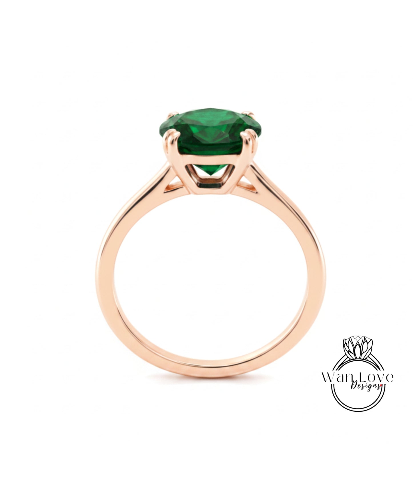 A gold ring with a large, green gemstone set in the center.