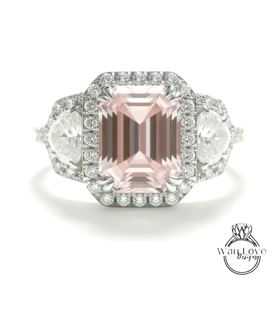 A stunning pink gemstone engagement ring with a halo of diamonds around it, set in a silver band.