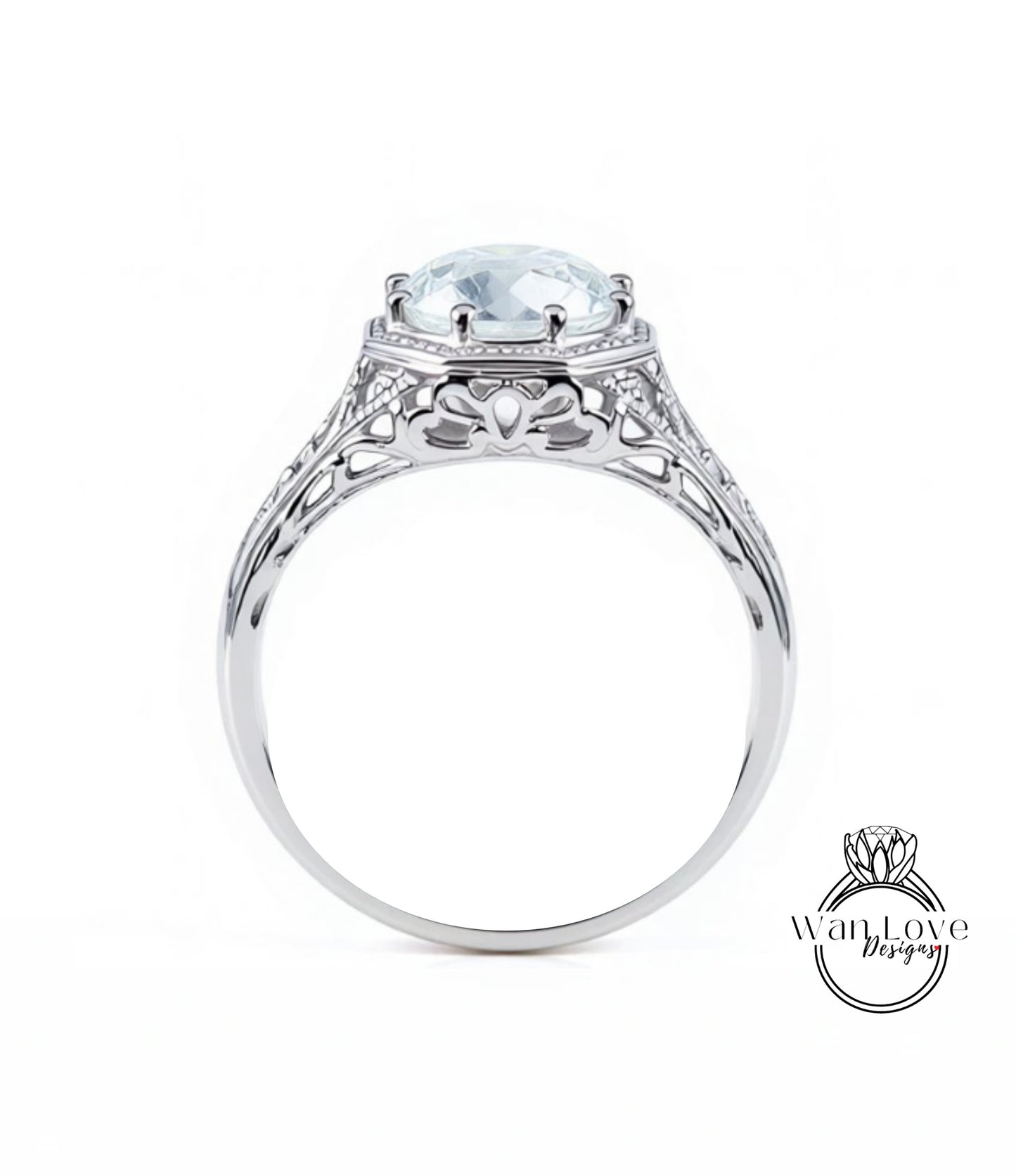 A silver engagement ring with a large, clear gemstone set in the center.