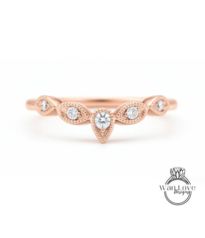 A rose gold ring with a central diamond and smaller diamonds arranged in a decorative pattern around it.