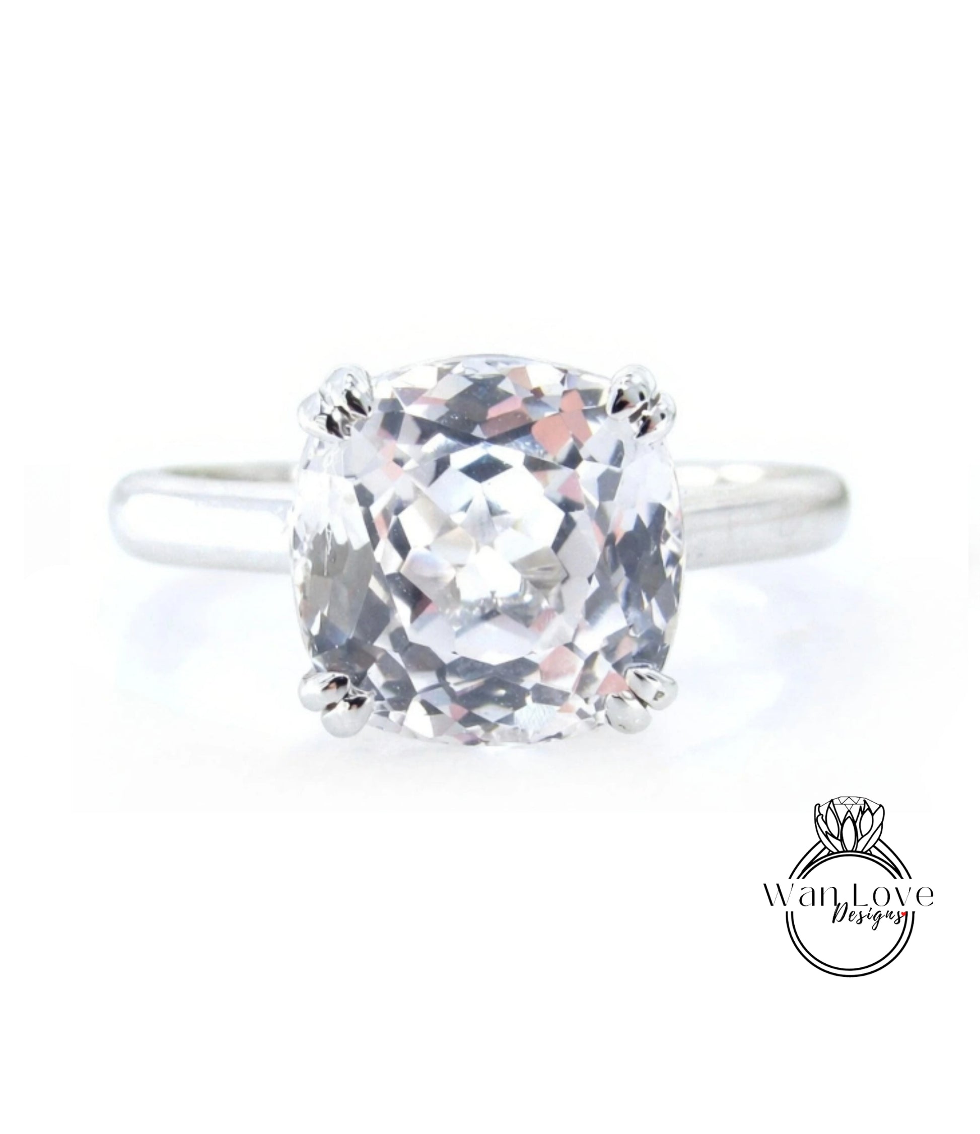 A close-up view of a diamond engagement ring with a large, clear gemstone set in a silver band.