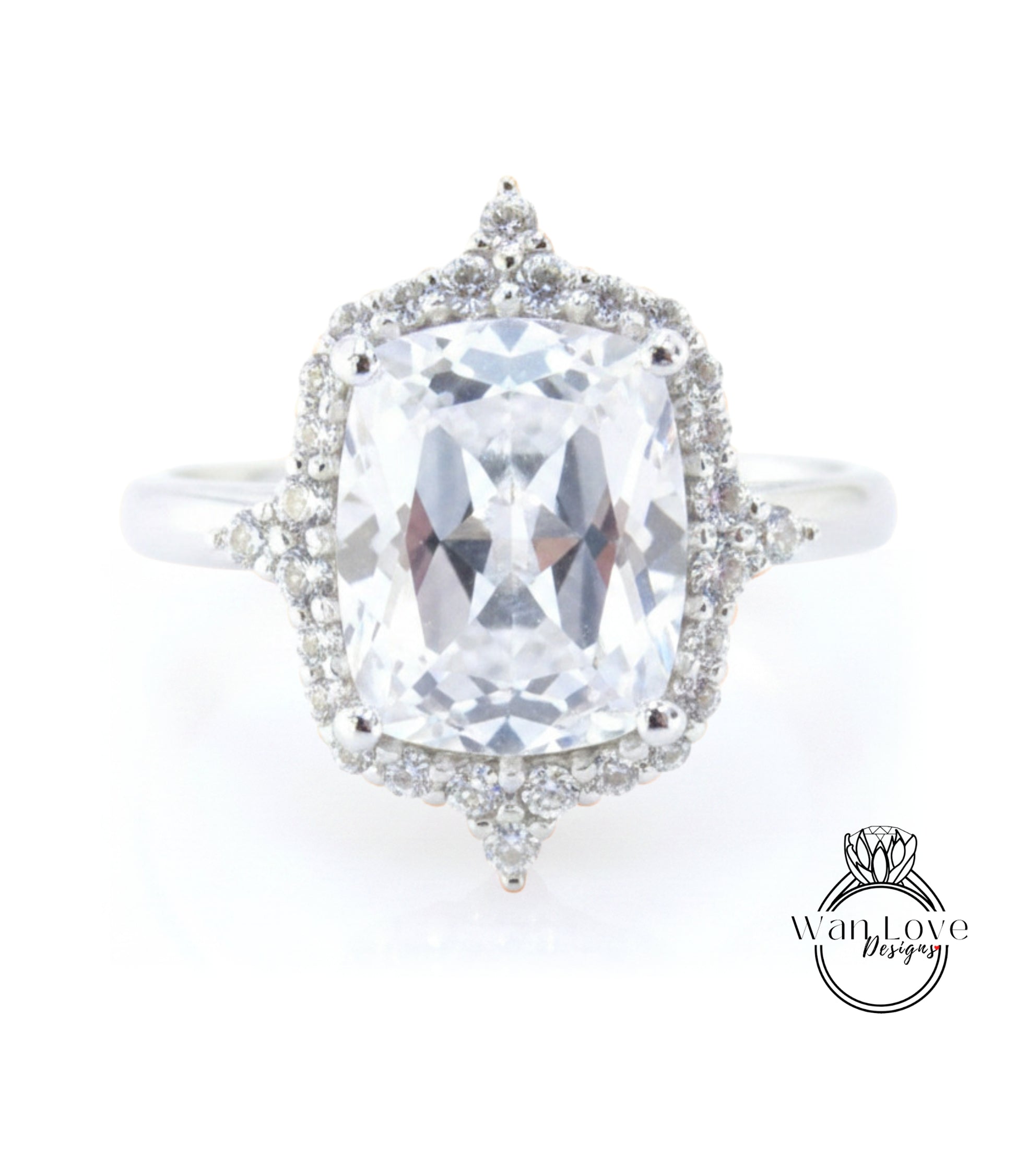 A large, clear gemstone ring with a halo of smaller diamonds around the center stone.