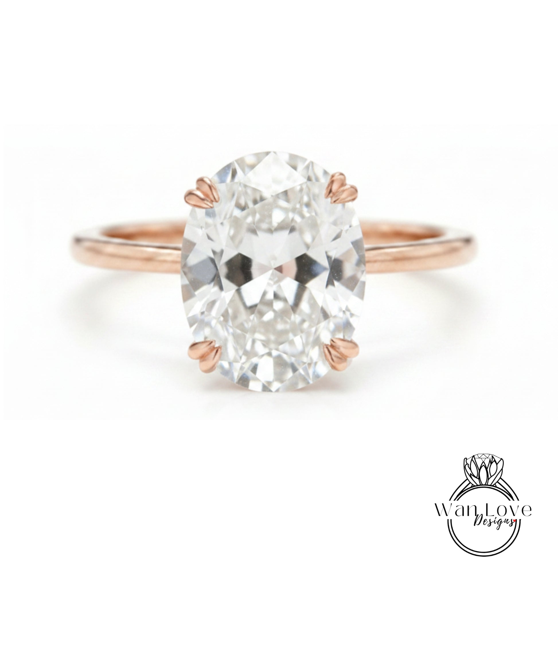 A close-up of a rose gold ring with a large oval-shaped diamond set in the center.