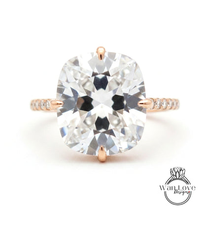 A large, clear diamond engagement ring with a prominent center stone and a delicate band.