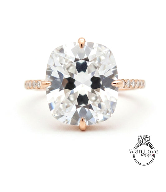 A large, clear diamond engagement ring with a prominent center stone and a delicate band.