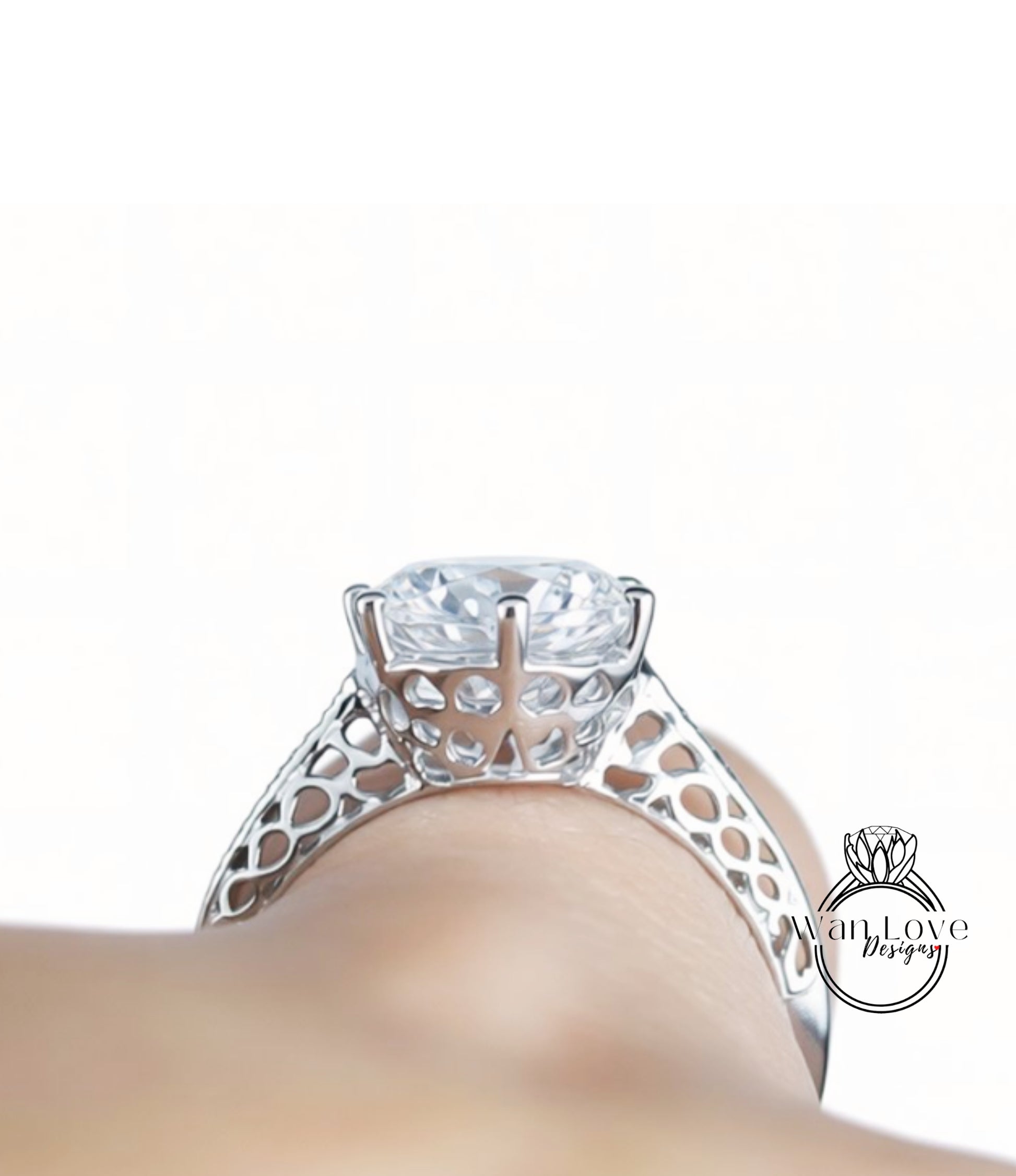 A close-up view of a diamond engagement ring on a person's hand, showcasing the intricate metalwork and the large central diamond.