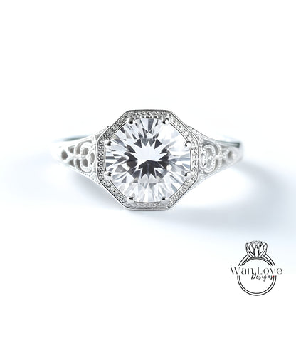 A close-up view of a diamond engagement ring with a large central diamond surrounded by smaller diamonds set in an ornate band.