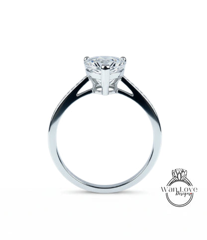 A silver engagement ring with a large diamond set in the center.