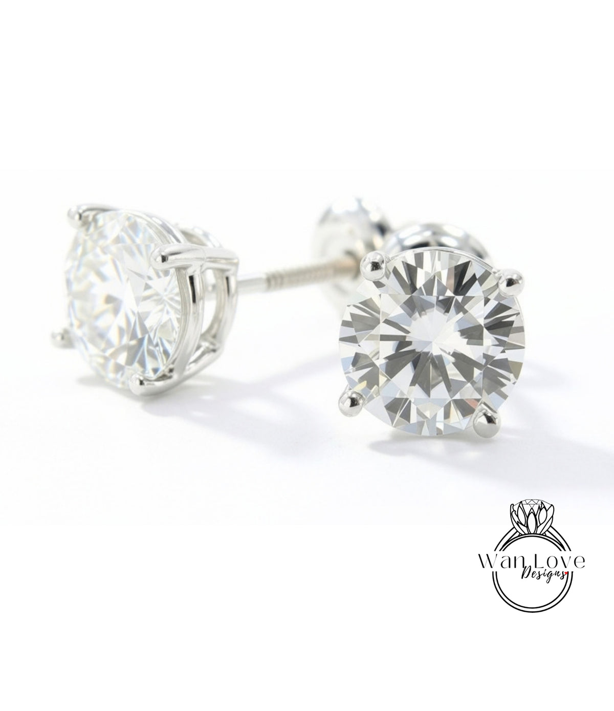 A pair of elegant diamond earrings with a large, brilliant-cut diamond set in a silver metal frame.