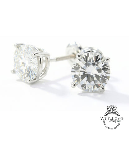 A pair of elegant diamond earrings with a large, brilliant-cut diamond set in a silver metal frame.