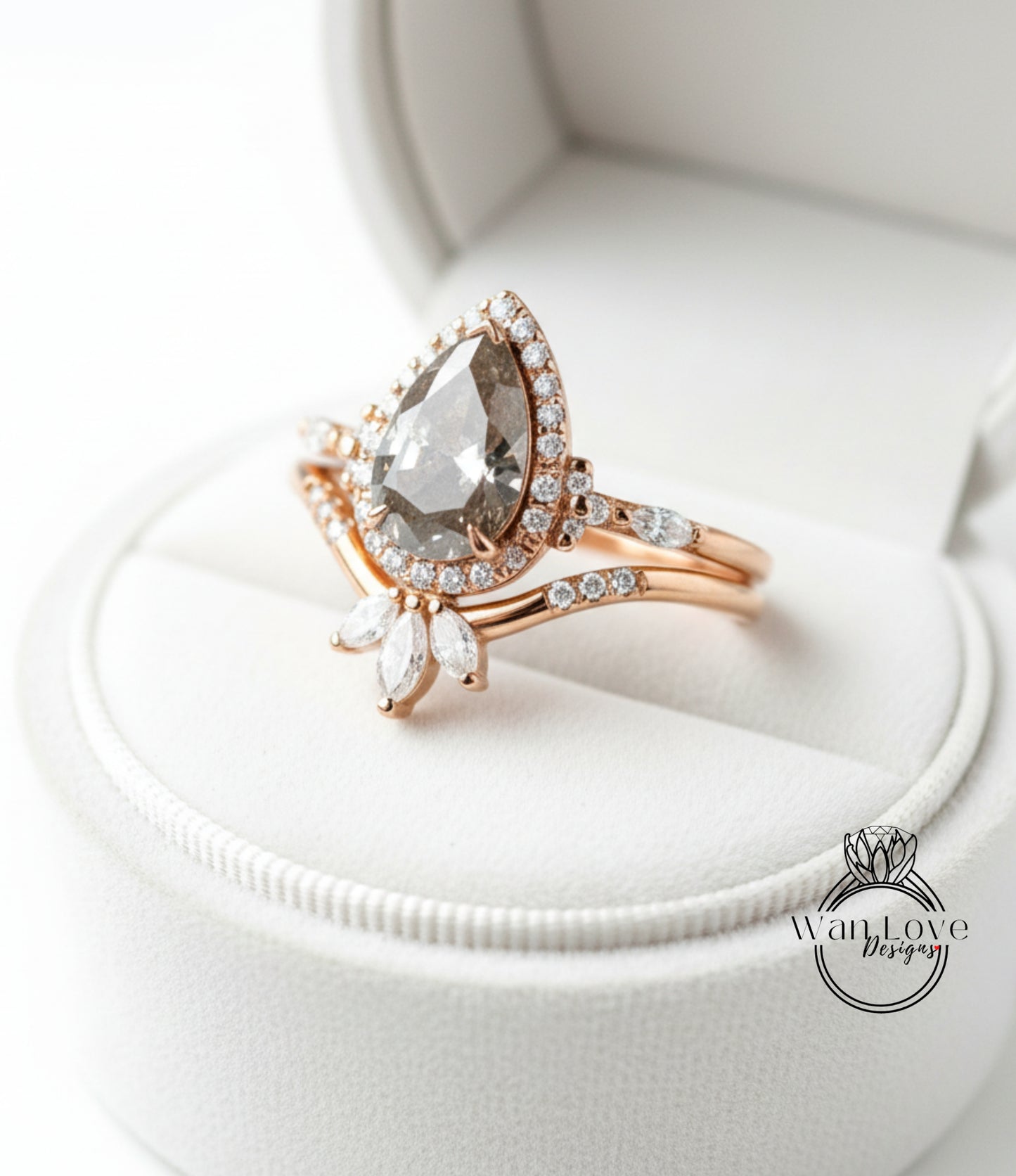 A close-up view of a gold ring with a large diamond set in the center, surrounded by smaller diamonds, placed in a white jewelry box.