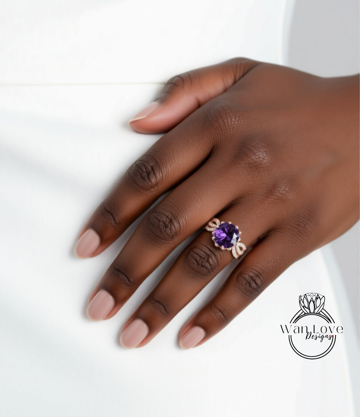 A close-up of a hand wearing a ring with a purple gemstone.