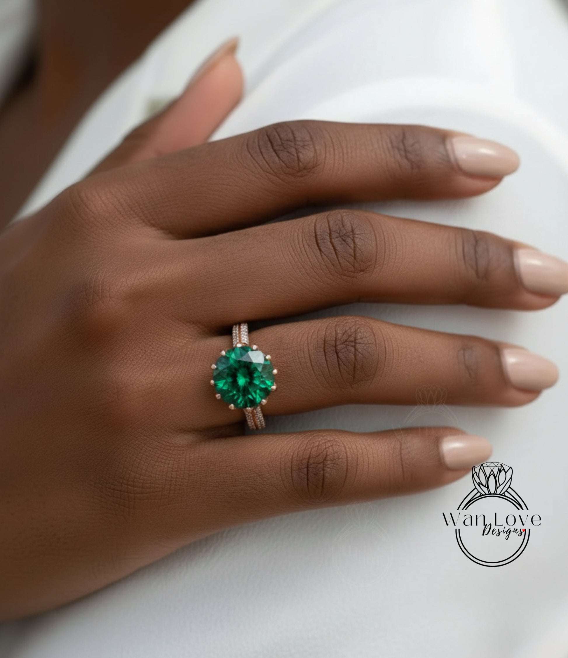 A close-up of a hand wearing a large, green gemstone ring on the ring finger.