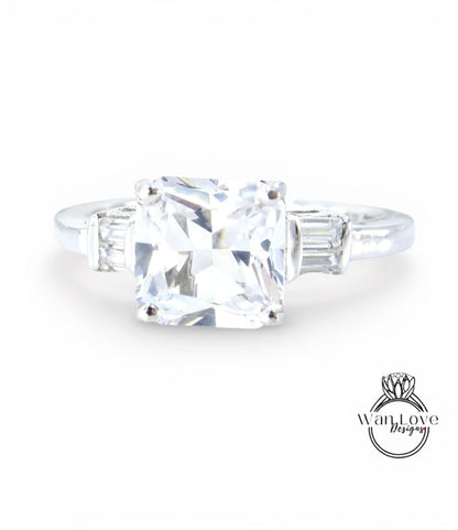 A diamond engagement ring with a large, clear gemstone set in a silver band.