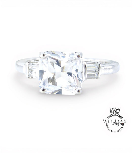 A diamond engagement ring with a large, clear gemstone set in a silver band.
