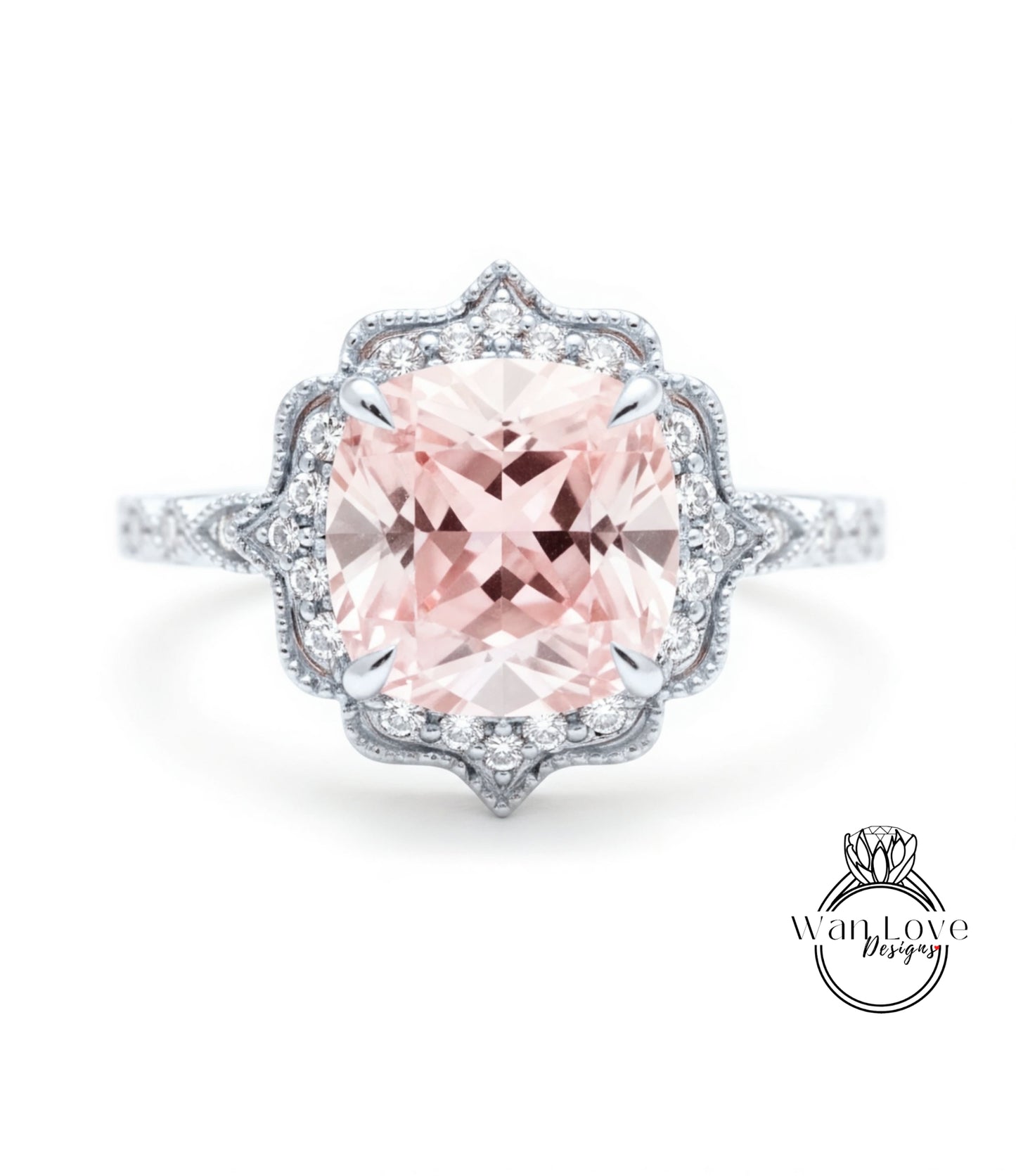 A stunning pink gemstone engagement ring with a halo of smaller diamonds around the center stone.