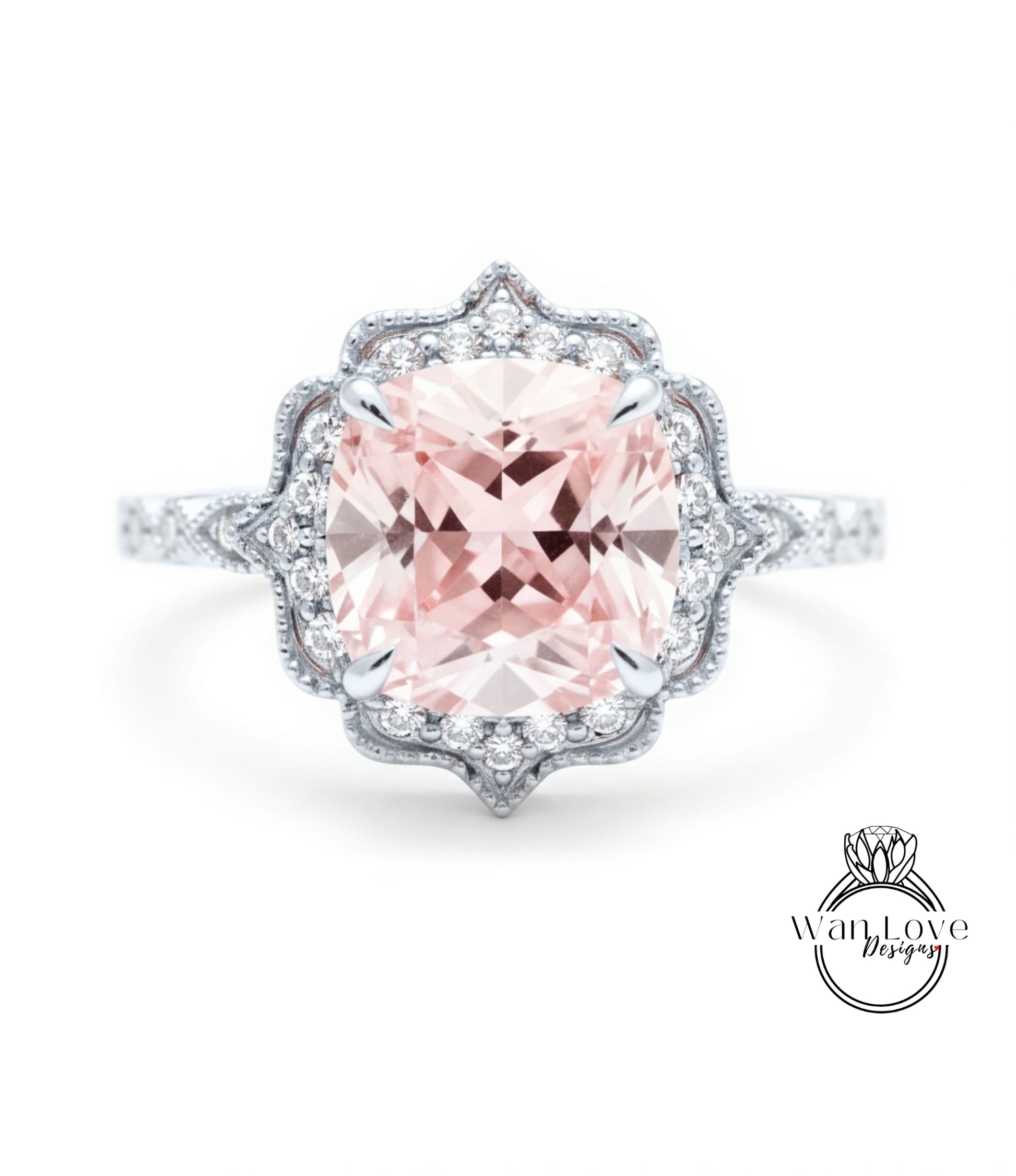 A stunning pink gemstone engagement ring with a halo of smaller diamonds around the center stone.