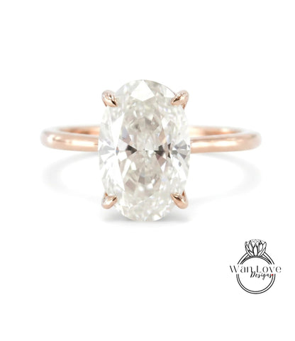 A large oval-shaped diamond engagement ring with a rose gold band.