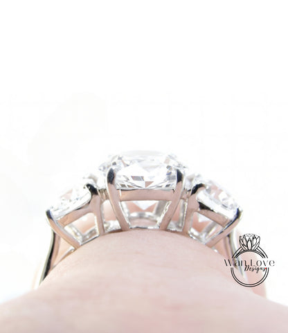A close-up view of a large, sparkling diamond ring on someone's hand.