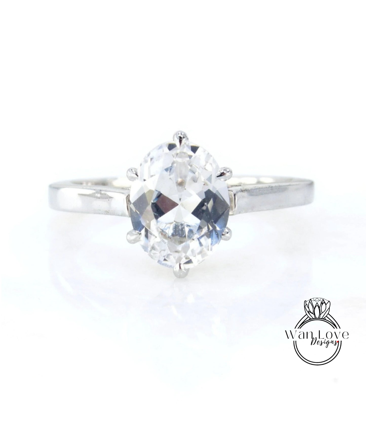 A close-up view of a diamond engagement ring with a large, clear gemstone set in a silver band.