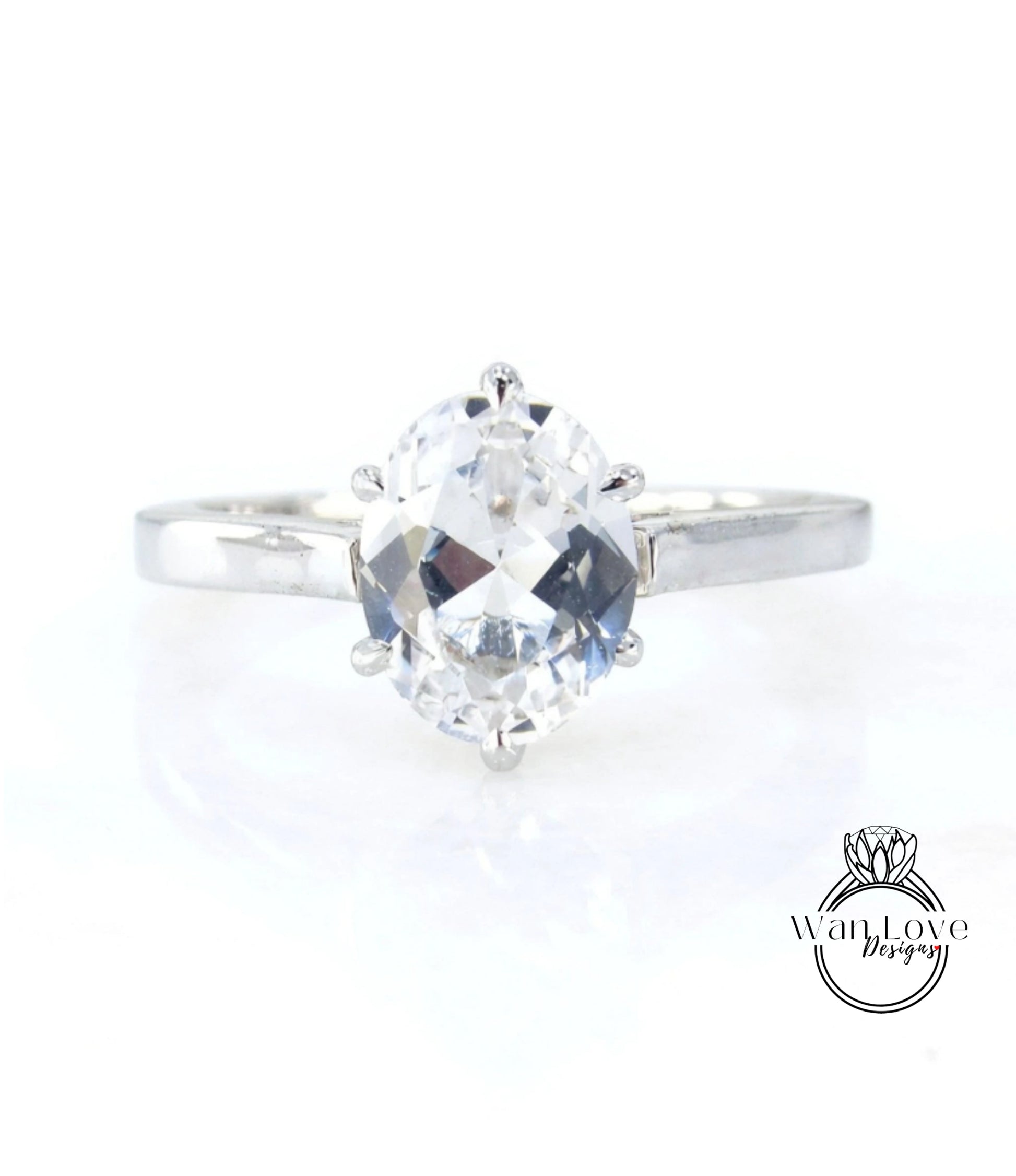 A close-up view of a diamond engagement ring with a large, clear gemstone set in a silver band.