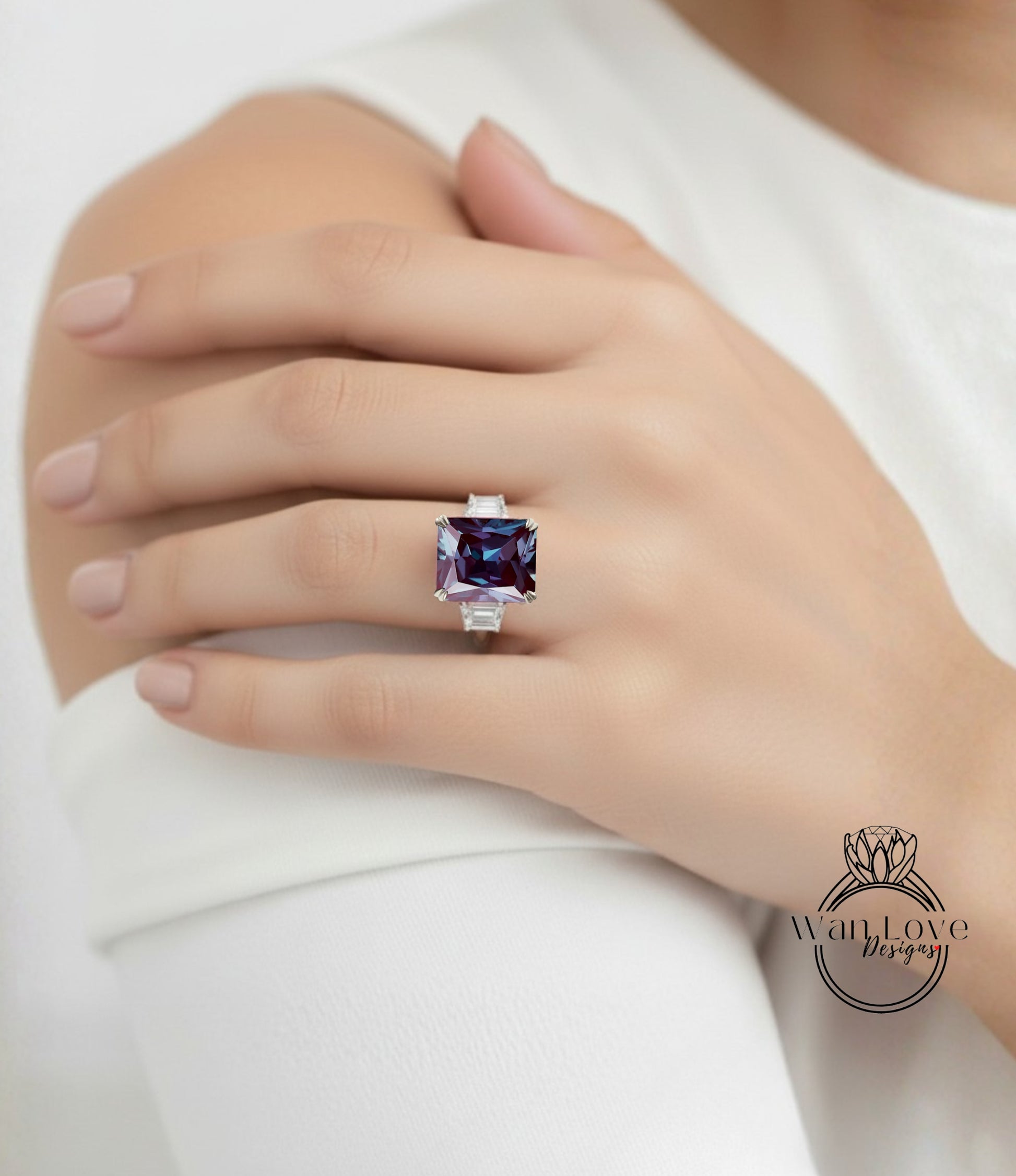 A close-up of a person's hand wearing a large, purple gemstone ring on the ring finger.