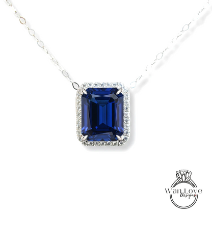 A necklace with a large blue gemstone, possibly a sapphire, set in a halo of smaller diamonds.