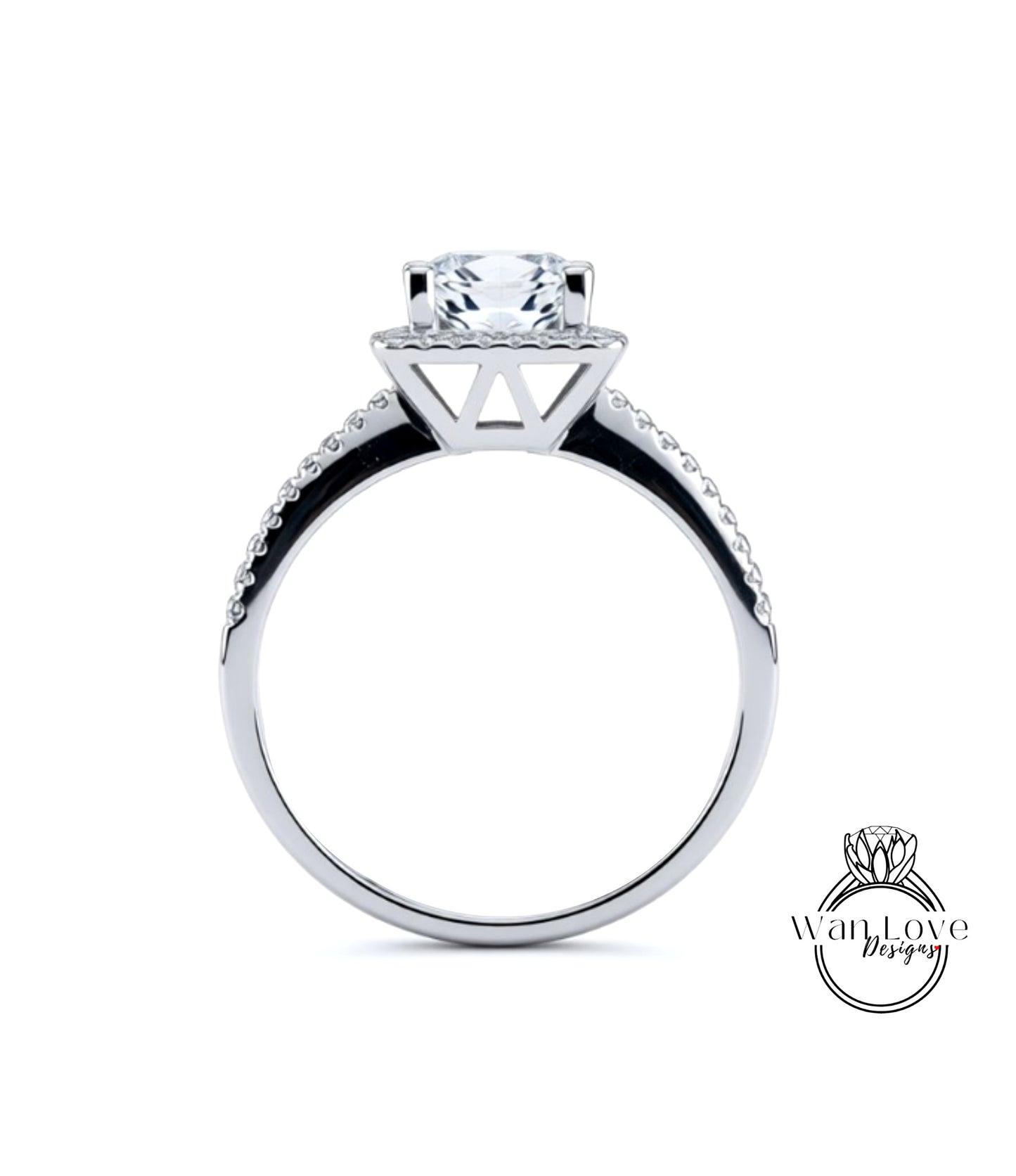 A silver engagement ring with a large central diamond and a halo of smaller diamonds around the top.