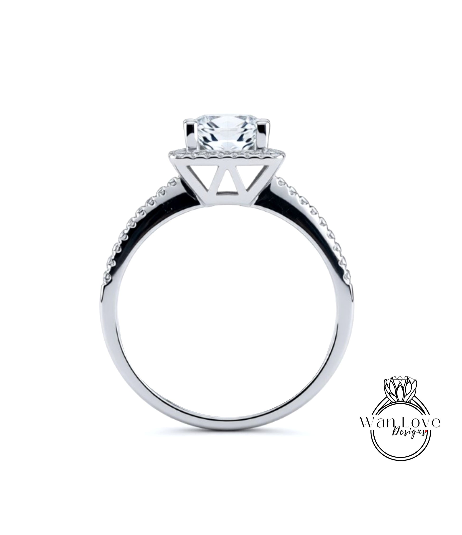 A silver engagement ring with a large central diamond and a halo of smaller diamonds around the top.