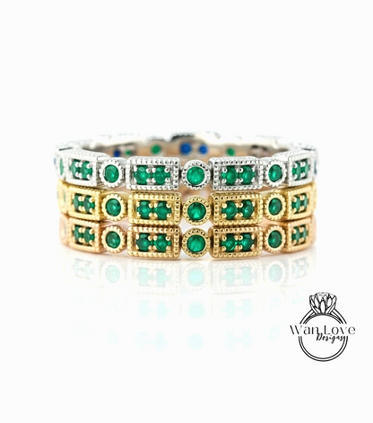 A ring with multiple layers of green gemstones set in a metallic band.