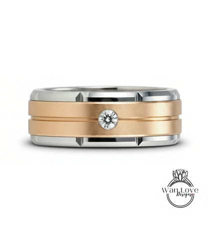 A gold and silver ring with a large diamond set in the center.
