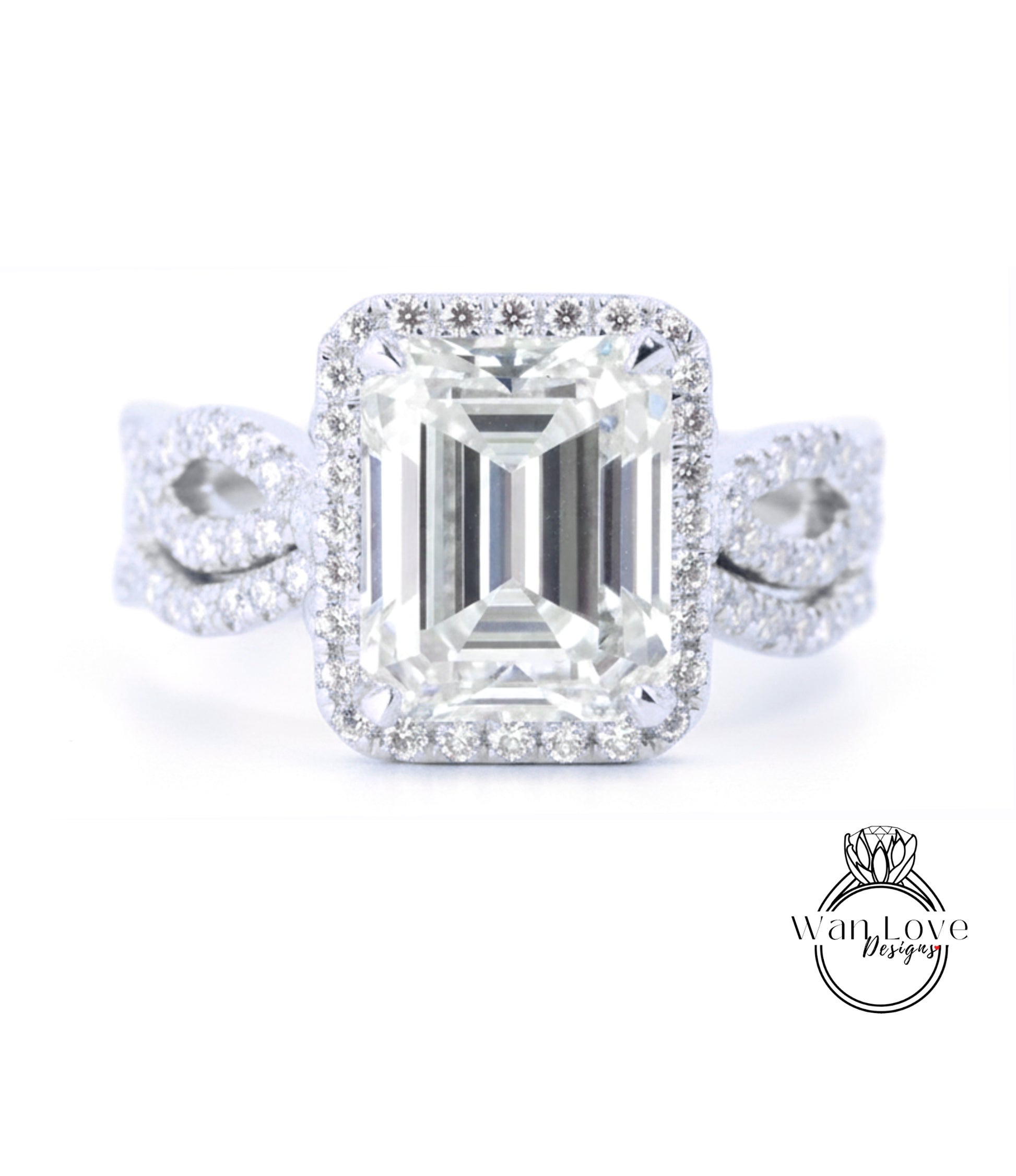 A stunning diamond engagement ring with a large, brilliant-cut emerald cut gemstone set in a halo of smaller diamonds, surrounded by a halo of smaller diamonds.