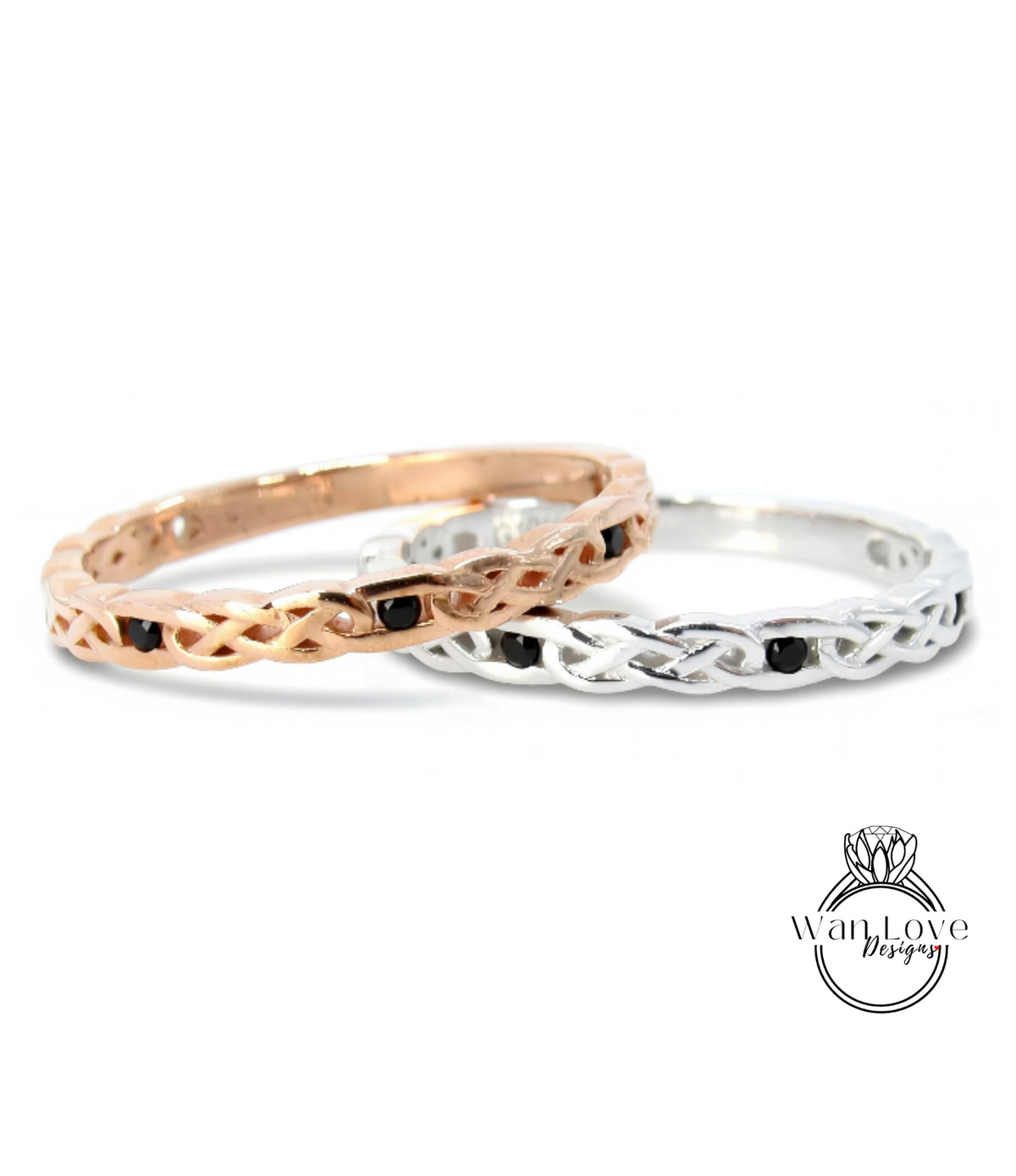 Two rings with intricate designs, one in gold and the other in silver, both featuring black stones.