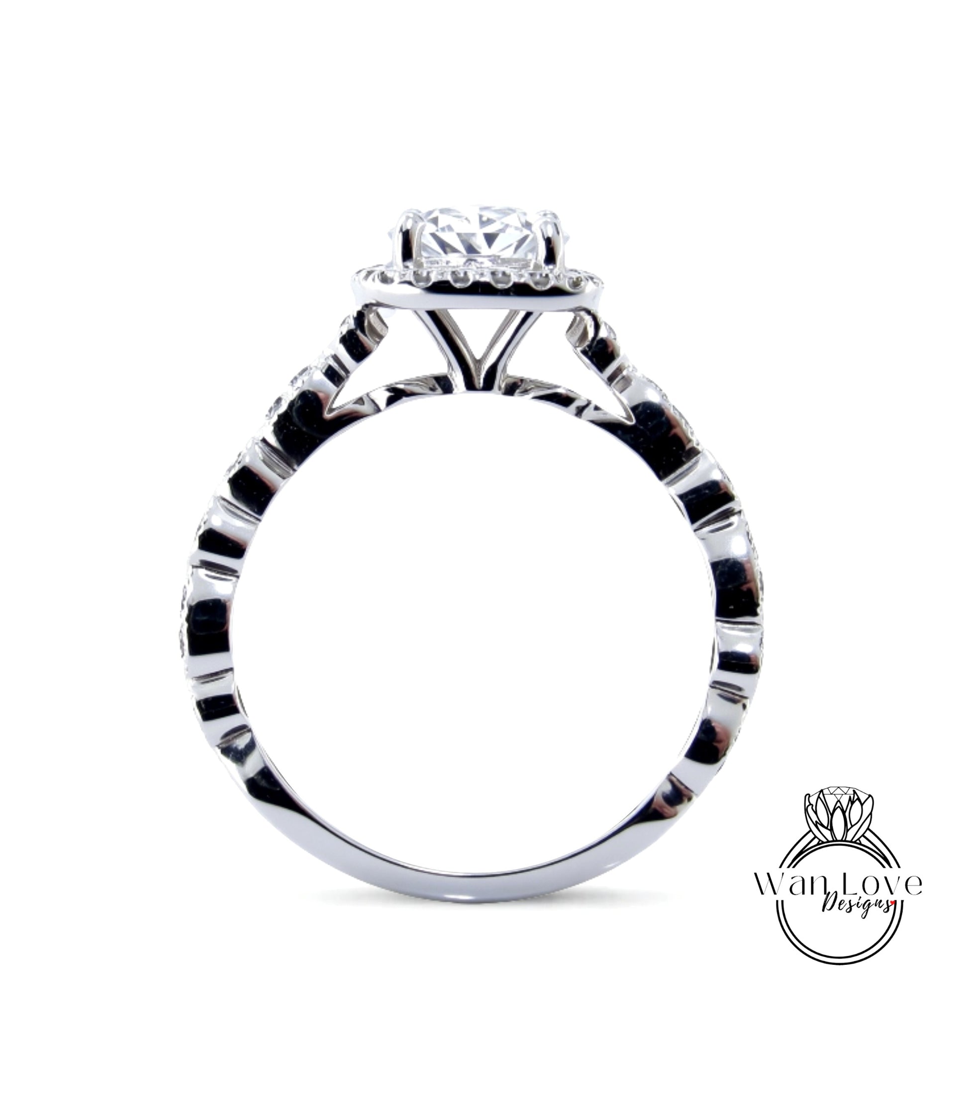 A close-up view of a silver engagement ring with a large central diamond surrounded by smaller diamonds.