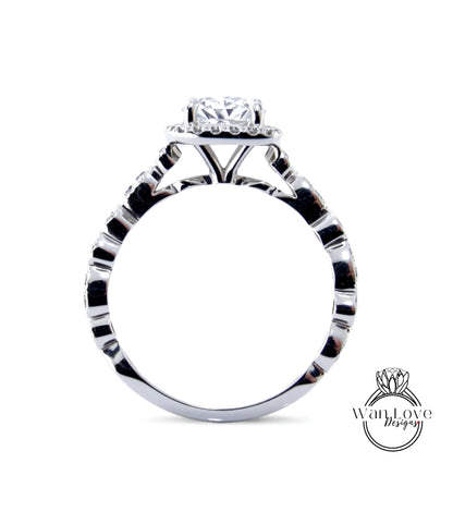 A close-up view of a silver engagement ring with a large central diamond surrounded by smaller diamonds.