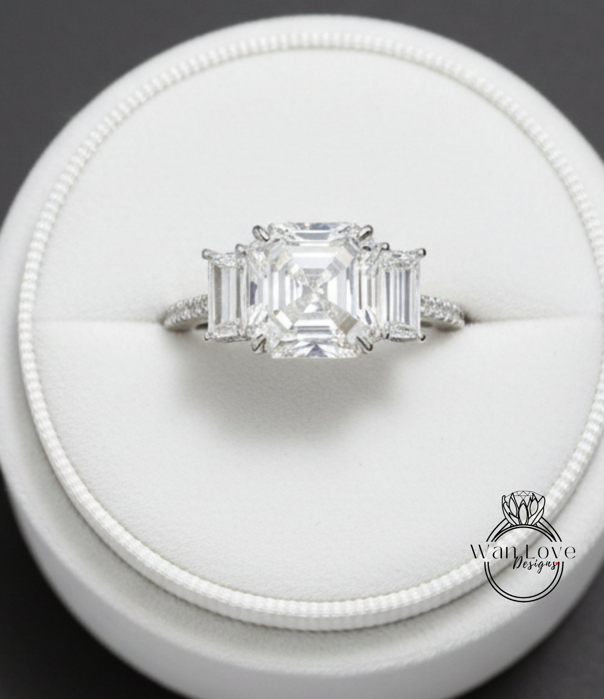 A close-up view of a diamond engagement ring displayed in a white jewelry box.
