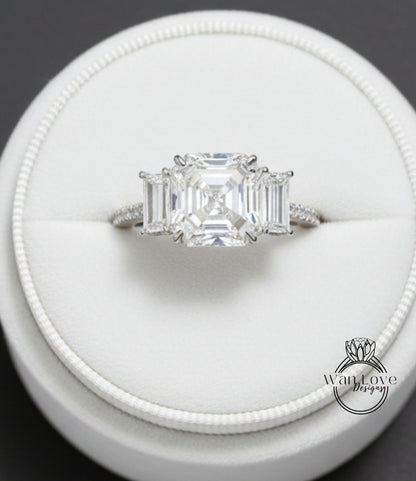 A close-up view of a diamond engagement ring displayed in a white jewelry box.