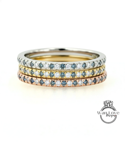 A stack of three rings with blue, yellow, and pink gemstones set in a silver band.