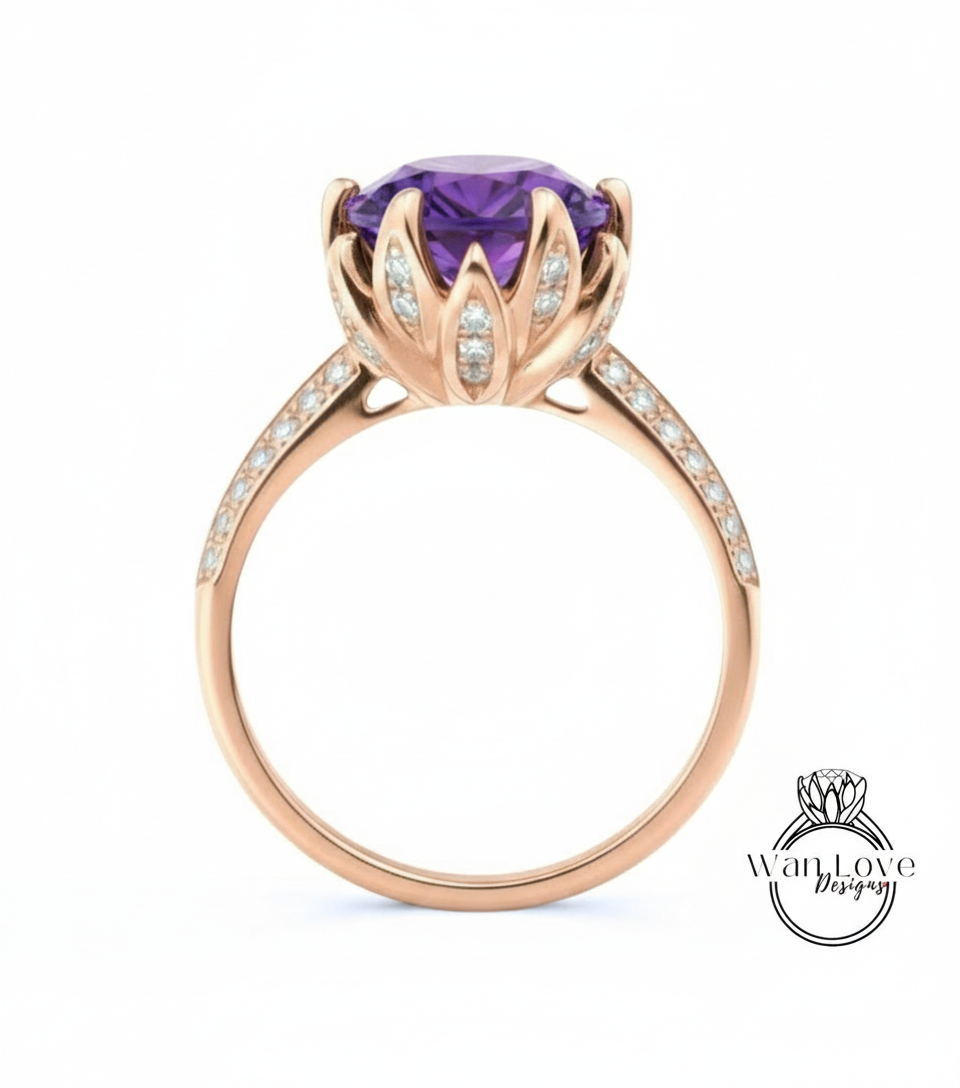A gold ring with a large purple gemstone, likely an amethyst, at the center. The ring has a delicate flower-like design around the gemstone, and the band is adorned with small diamonds.
