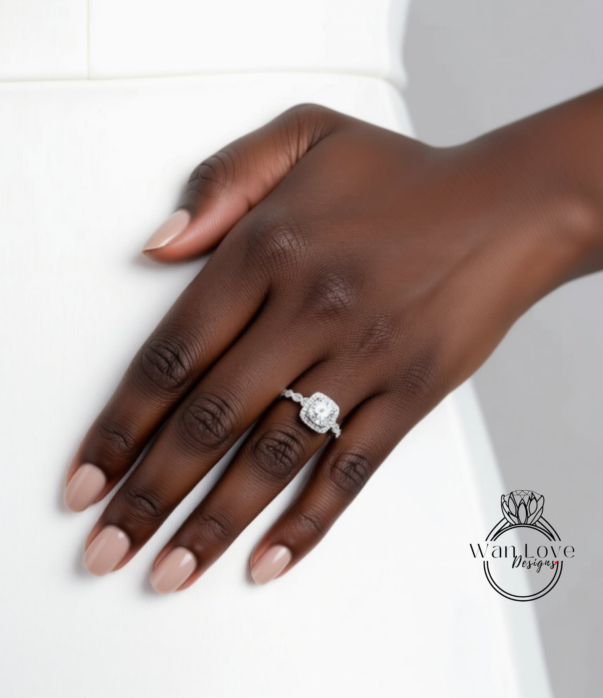 A close-up of a hand wearing a diamond engagement ring.