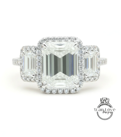 A close-up of a diamond engagement ring with a large central diamond surrounded by smaller diamonds on either side.