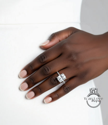 A close-up of a hand wearing a diamond engagement ring.